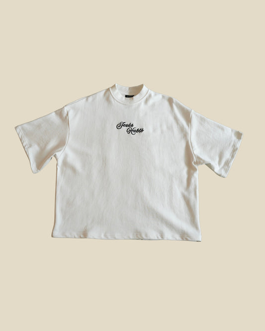 KAIROS JESUS HABLÓ bone oversized French Terry tee front with a black cursive 'JESUS HABLO' embroidery logo printed on the chest, displayed flat against a solid beige background.
